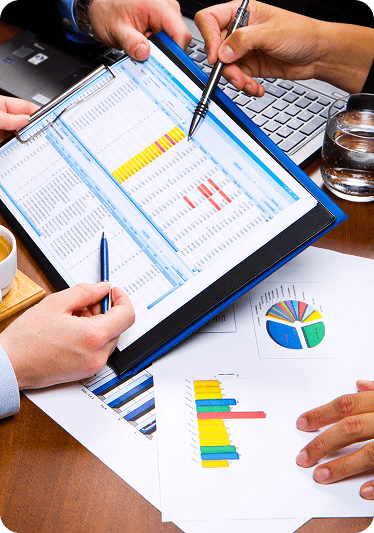 Weekly certified payroll records and California DE 9 and DE 9C returns on a desk at the G&S Accountancy office in Rancho Cucamonga, California.